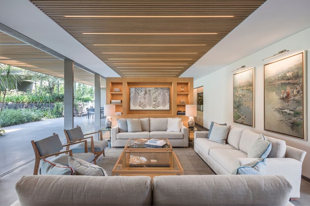 An interior shot that captures the living room space fully furnished and seamlessly integrated with the adjacent outdoor area.