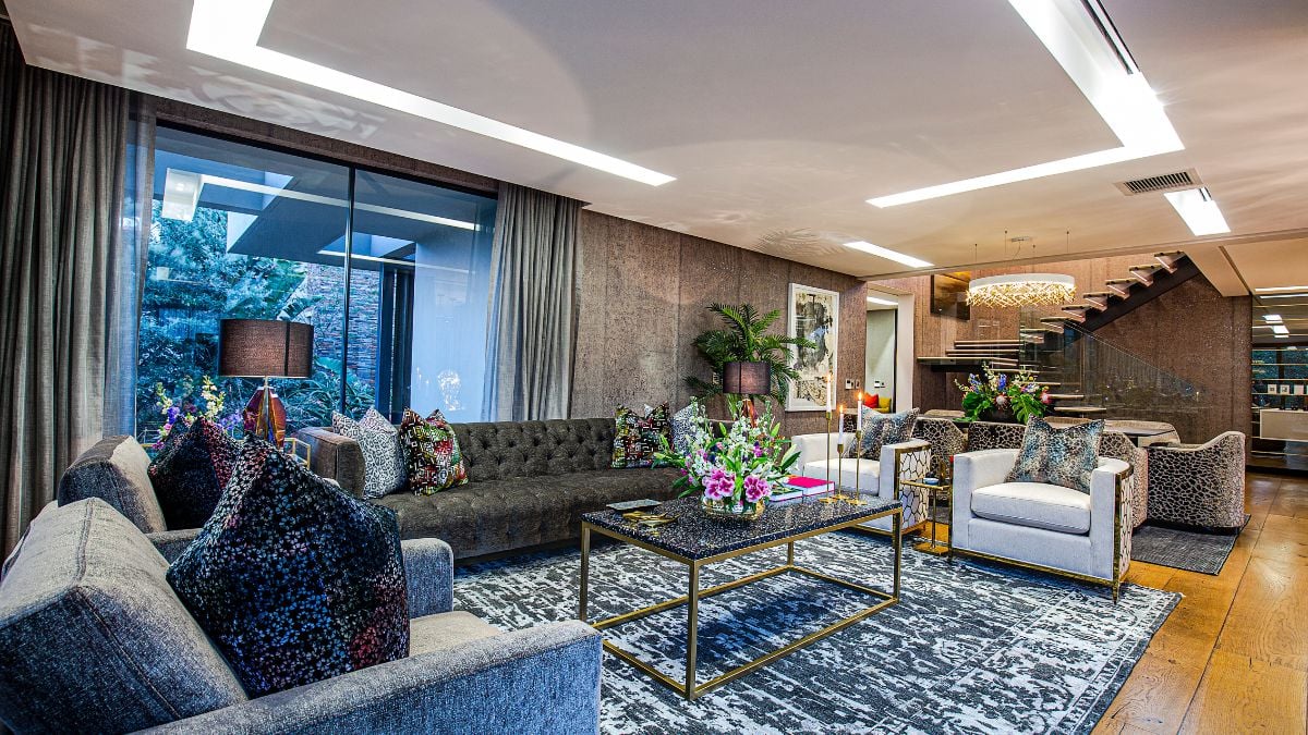 The living area exudes luxury and elegance, with concrete form that extends to both sides of the interior and beyond the back corners.