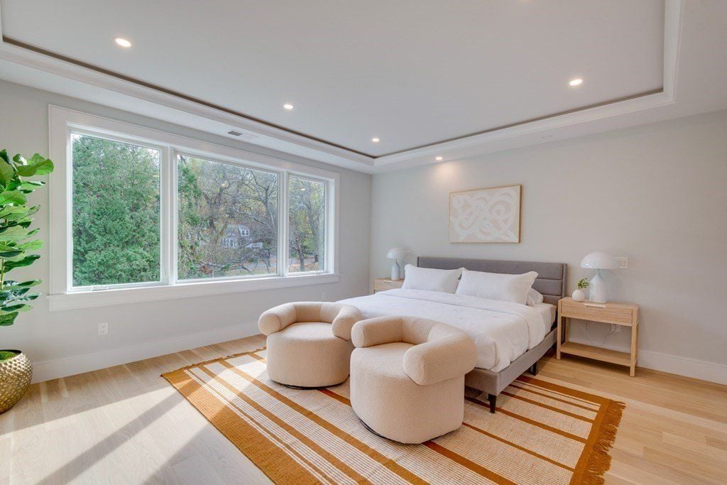 The bedroom features a double-size bed and an area rug that gives off a cozy feel.