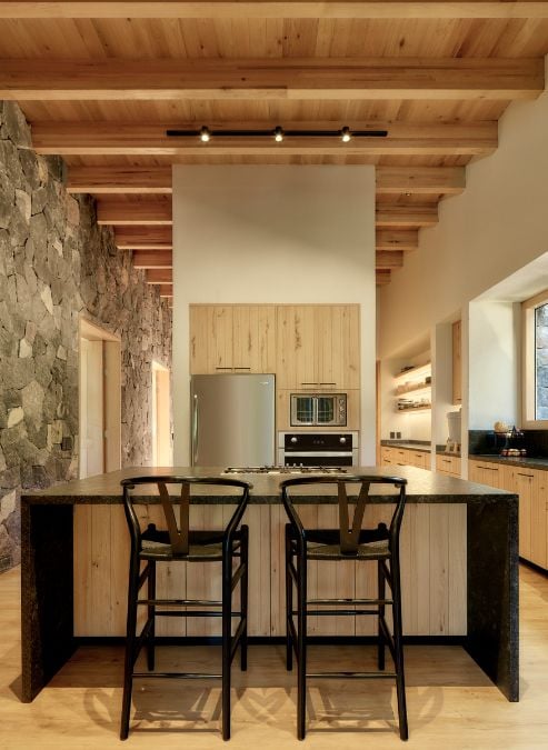 The kitchen includes a table and chairs for dining or casual use.