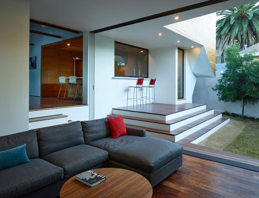 An interior shot of the living room filled with furniture, with a view of the outdoor area.