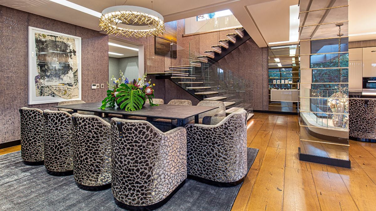 The dining area is visually appealing with a unique style that complements the decor. The chandelier makes this area even more appealing.