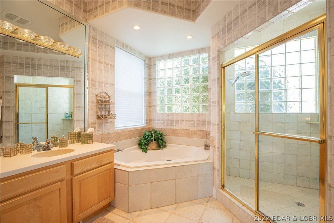 The bathroom features a built-in hot tub spa and a shower cubicle with glass walls.