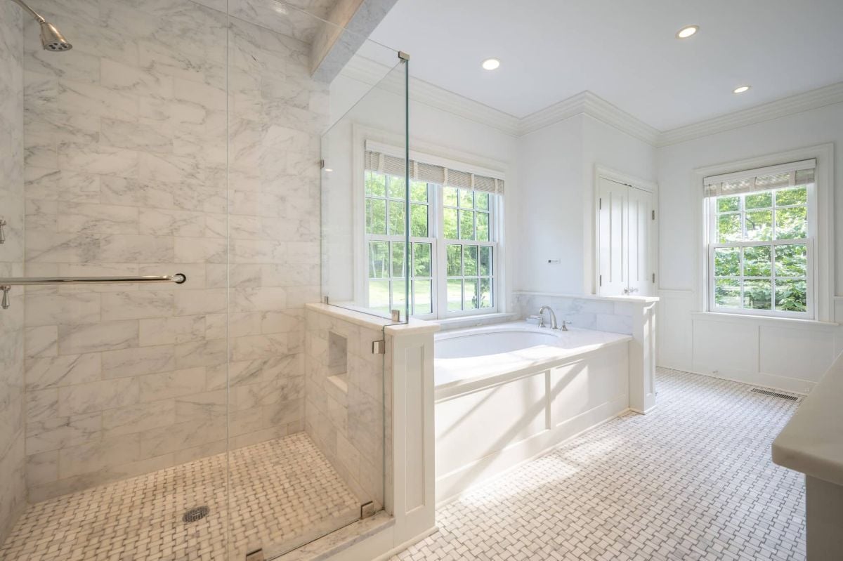 The bathroom features a bathtub and a shower cubicle with a glass enclosure.