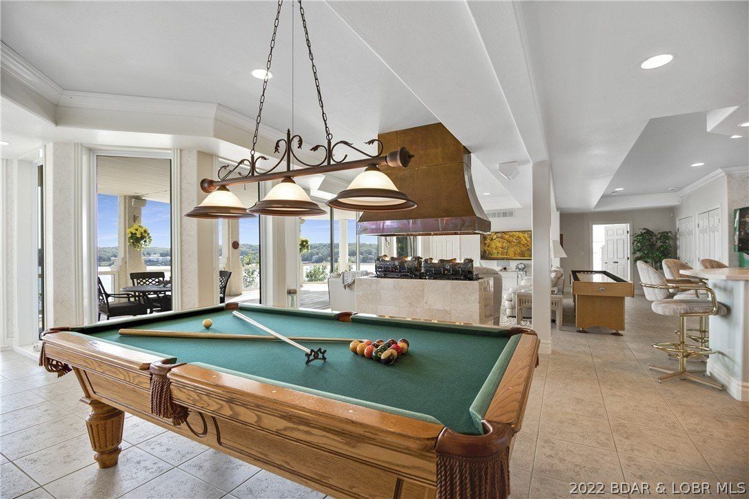 The recreational room features a billiard table and a home bar perfect for relaxation.