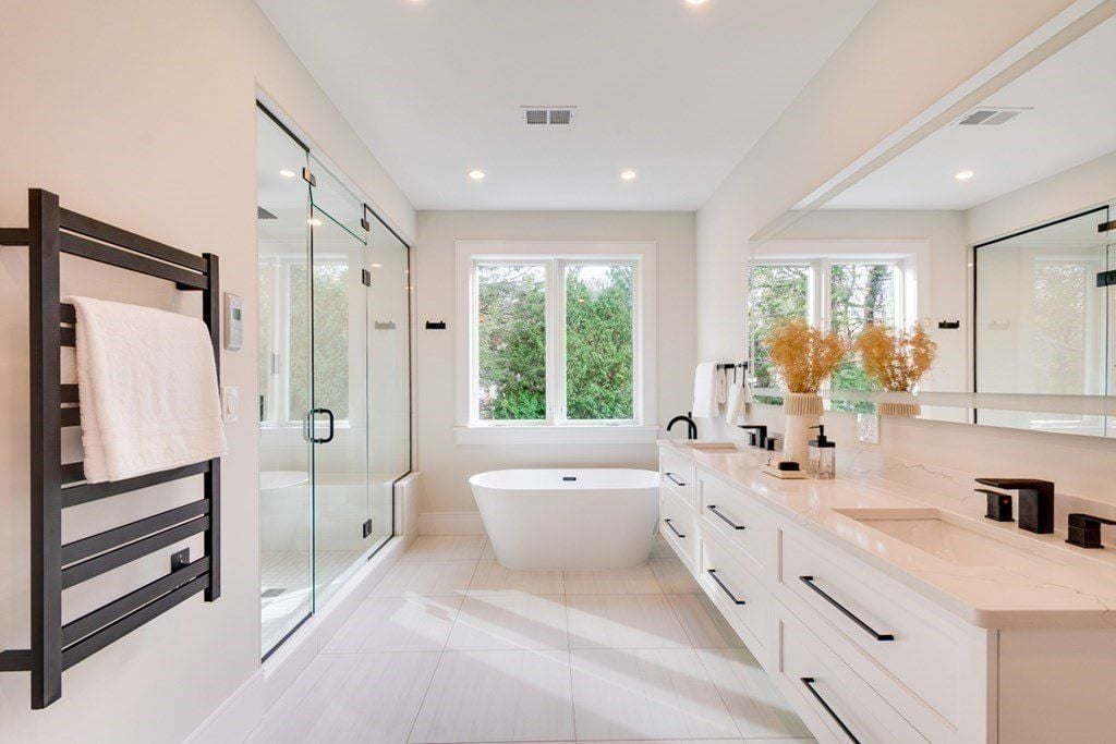 The bathroom features a floating vanity with a tile countertop and a free-standing bathtub.