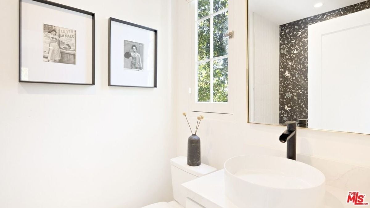 The bathroom features a toilet and vanity with a vessel sink.
