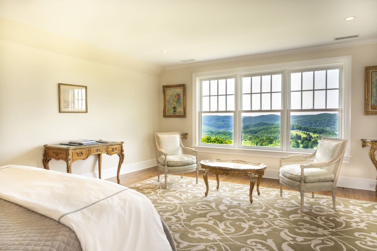 The bedroom features a carpet, and a coffee table gives off a luxurious feel.