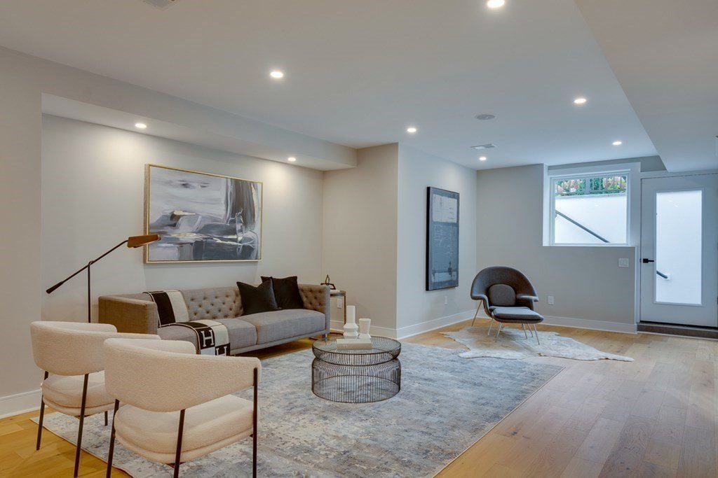 The lounge features a sofa and an area rug that gives a cozy feel.