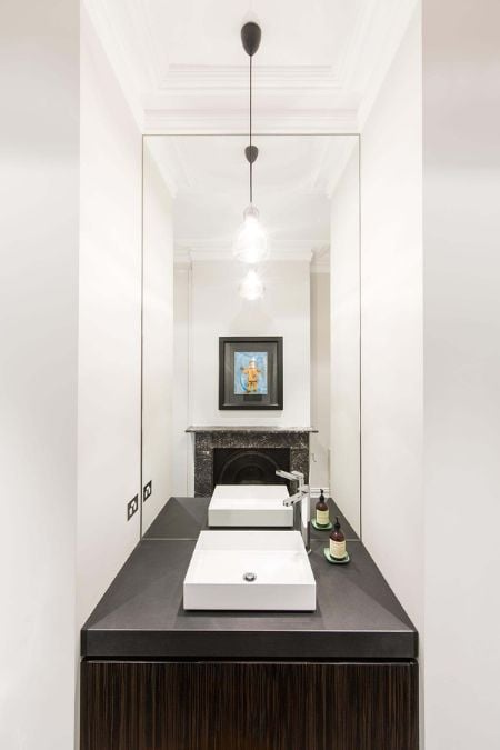 This is an interior photograph that centers on a single basin sink and a mirror.