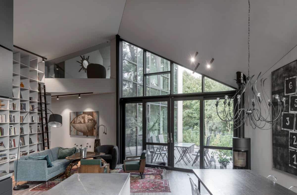 Living room with mismatched seats, a vintage area rug, and a built-in bookcase.