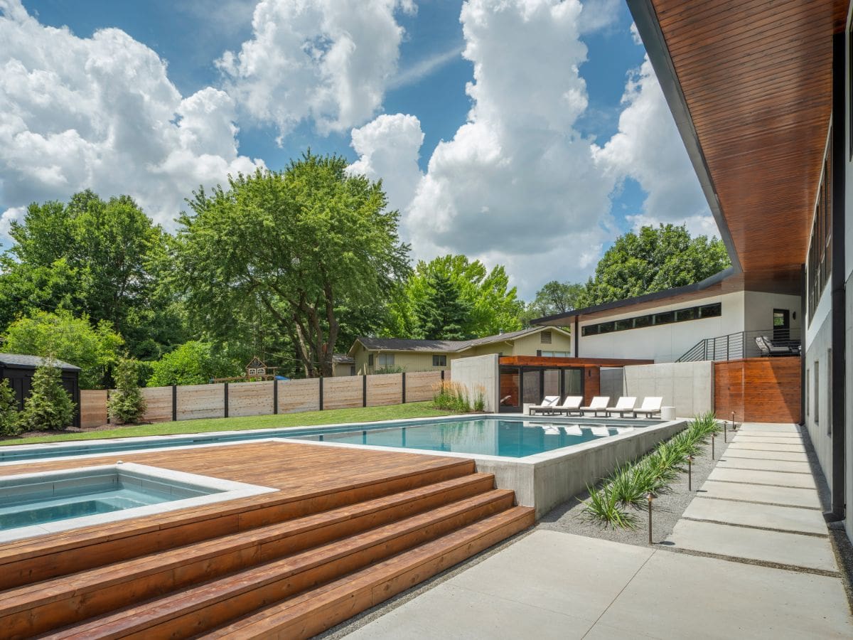 The swimming pool area, which is surrounded by beautiful trees and under the magnificent blue skies.