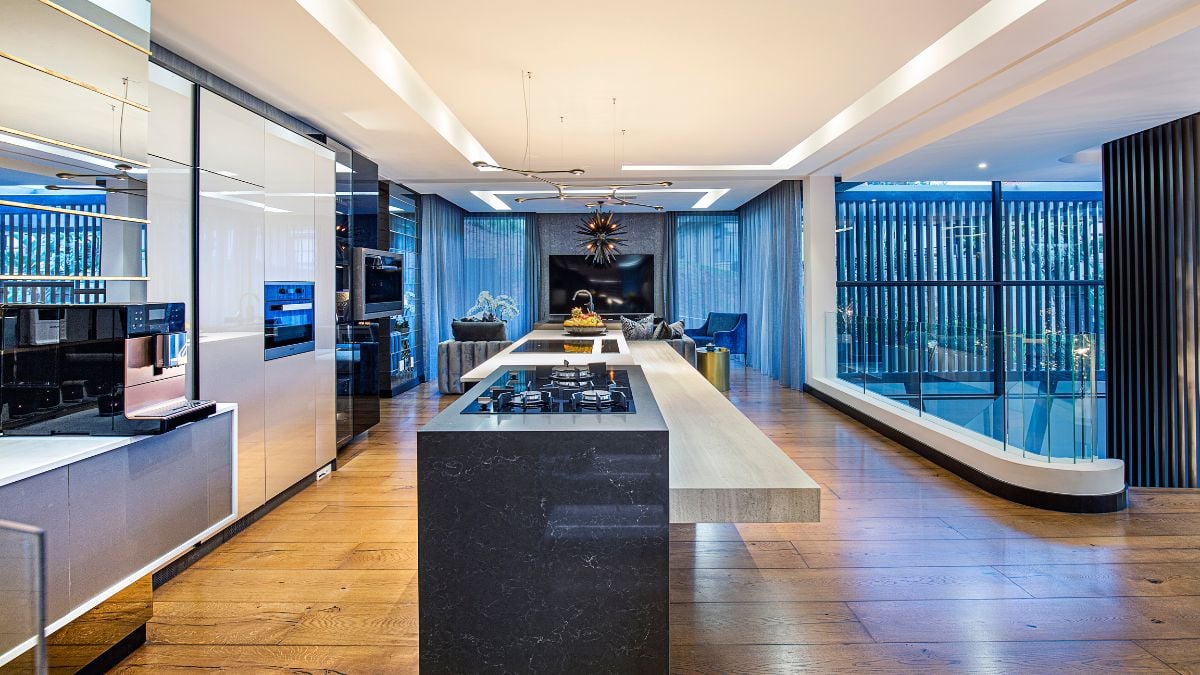 The living room, dining room, and stairway leading to the third level are all directly across from the kitchen.