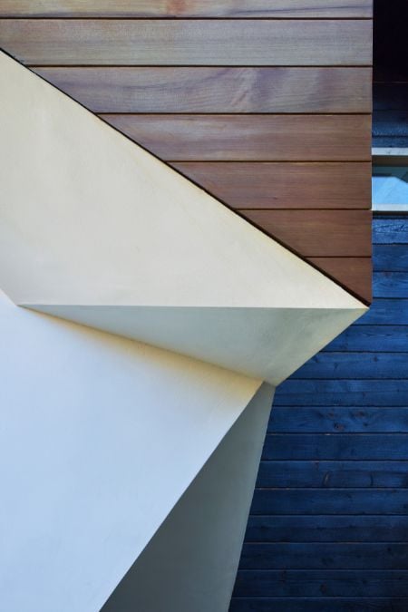 A focus shot featuring the architectural design of the wall of the house.