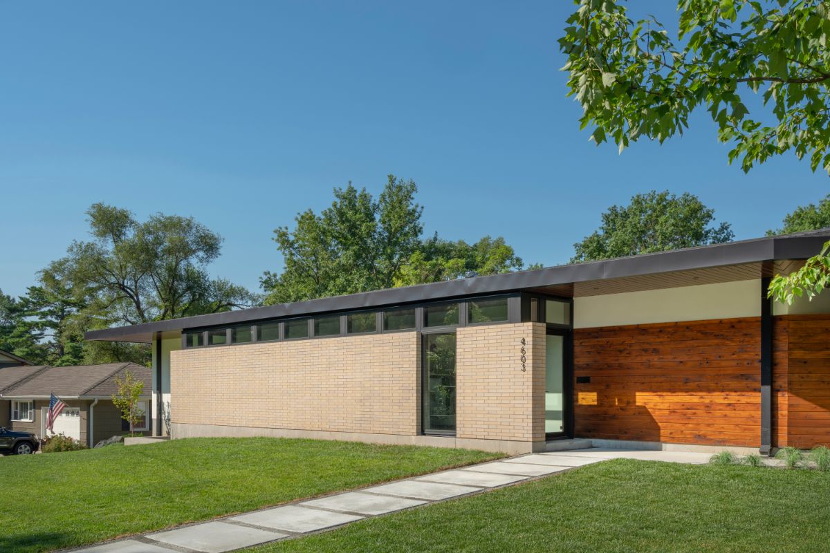 The approach to the residence greets one with a masonry facade, perforated in sections, running the long axis of the house.