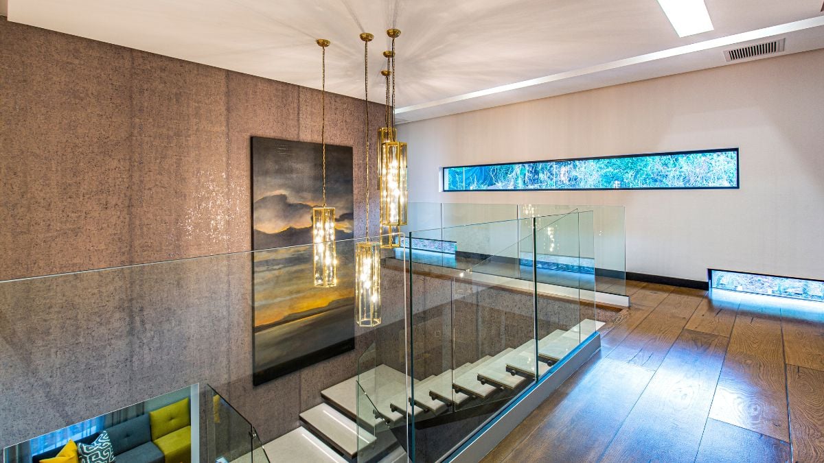 Only sporadic horizontal linear glass slits that appear to be randomly placed from the outside but are strategically placed inside break up this severe aspect.