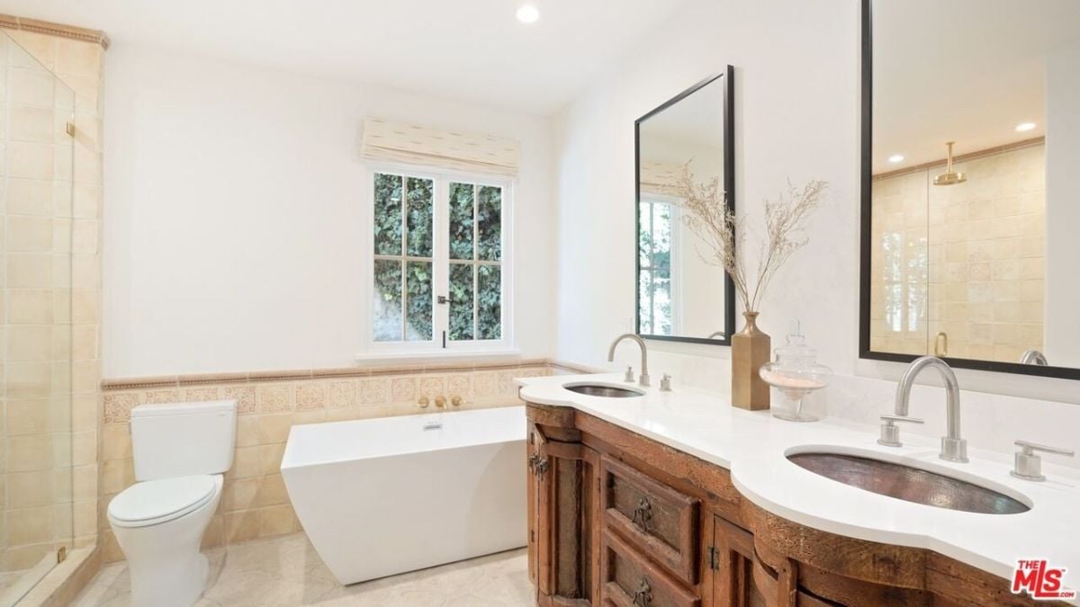The bathroom suite with freestanding tub, a large shower stall with a rain-forest shower head, and an expansive closet.