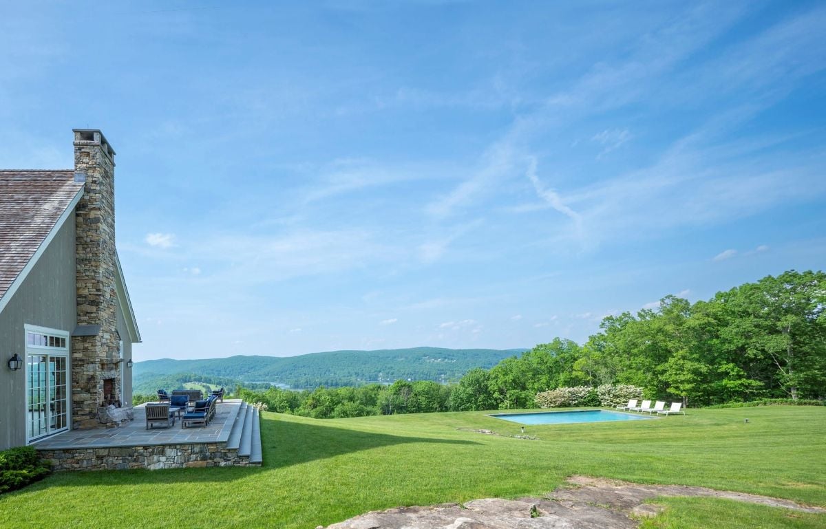 The view of the house featuring the pool and the patio.