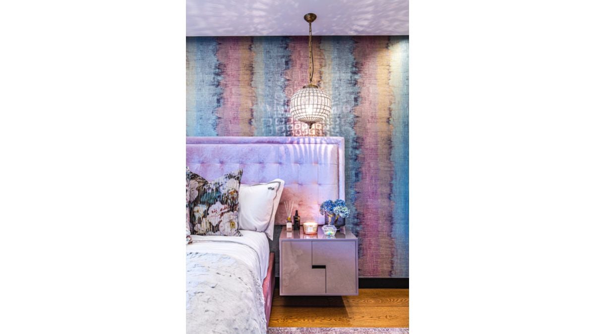 The wallpaper in this bedroom is vibrant and fits the bedframe and mattress as well.