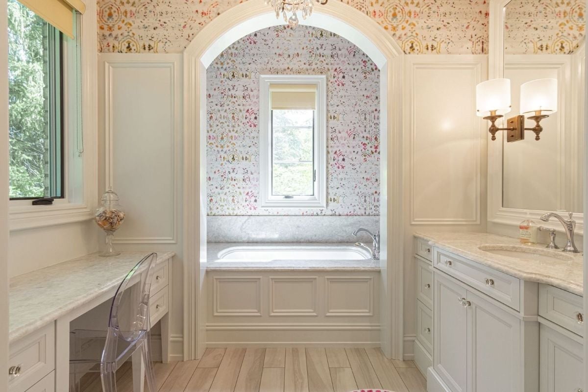 The bathroom features a built-in bathtub and a vanity with a granite countertop.