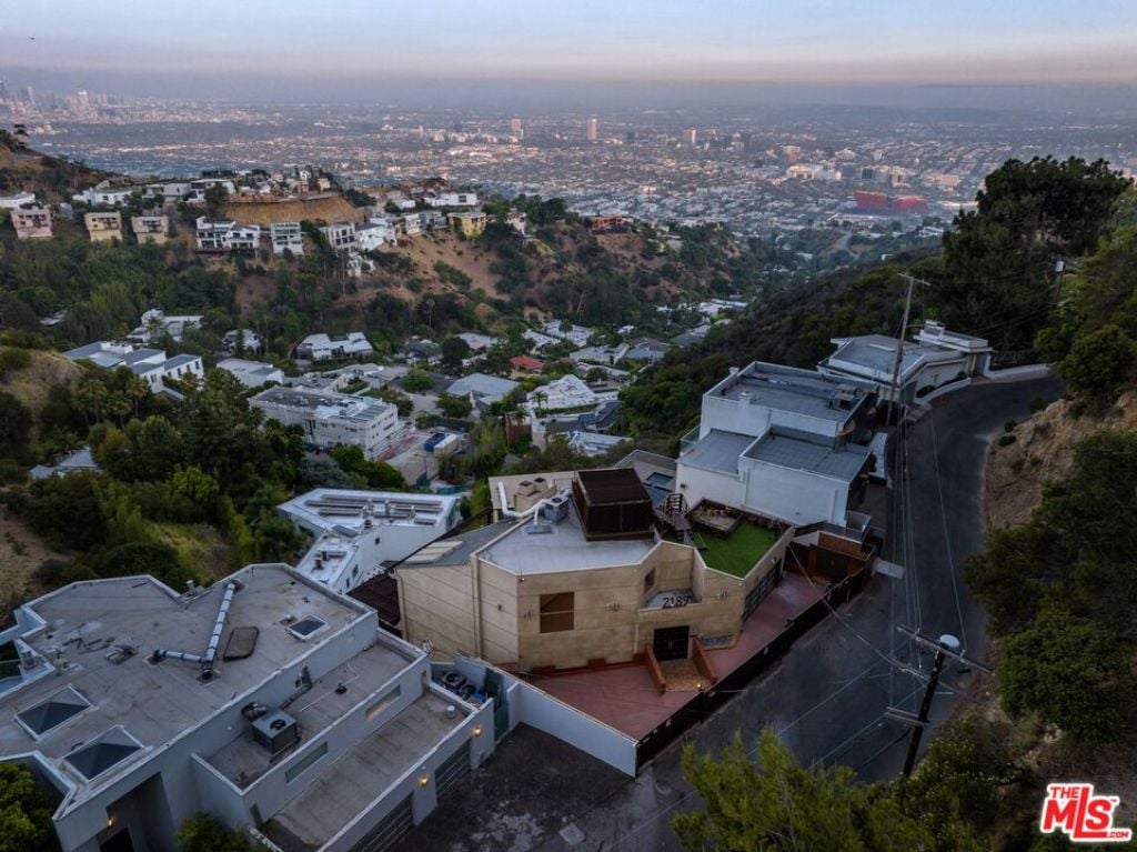 The impressive gated and three-story house nestled in the hills offered breathtaking views of the city below.
