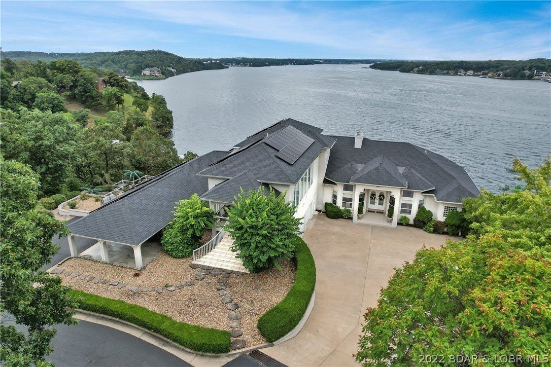 This gated compound has a main house, guest house, tennis court, putting green, 2 swimming pools (indoor & outdoor), dock (6 slips), 130 solar panels, & 15 Lots.