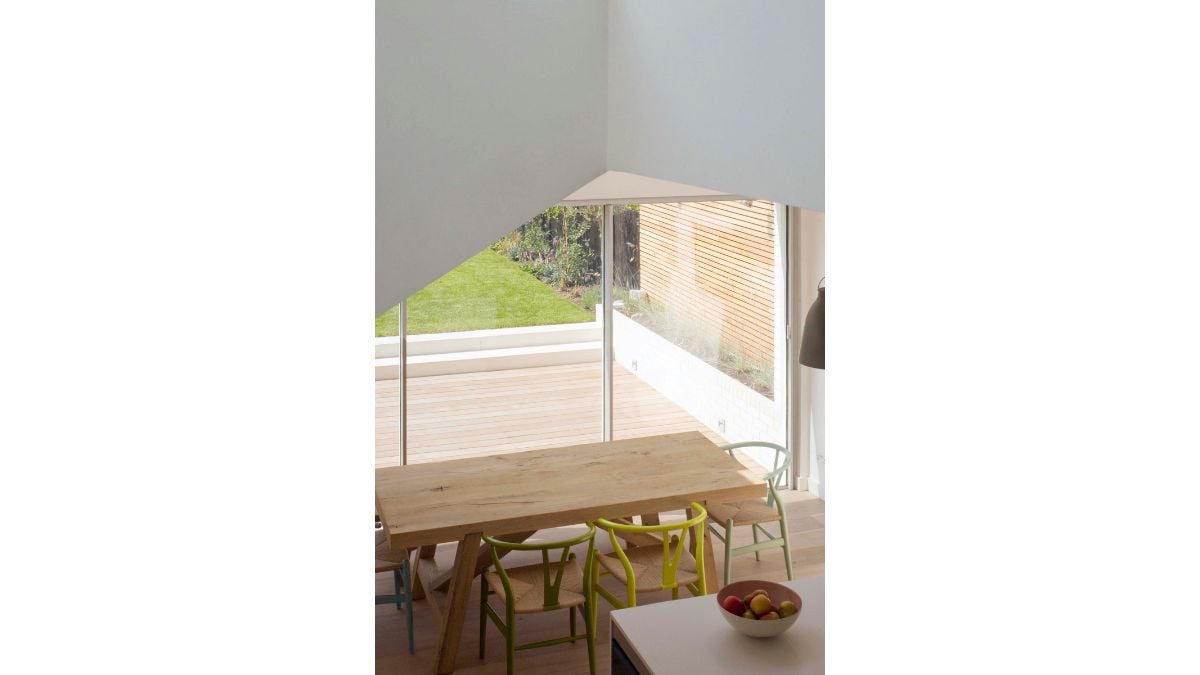 The glass above links the two spaces together and lets light into the kitchen's back area.
