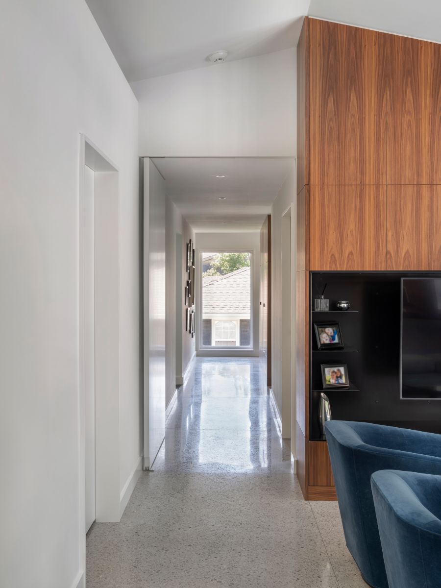 A shift off-axis provides an orientation to the main stair that is pulled out from the interior footprint, flowing linearly under the roof overhang. 