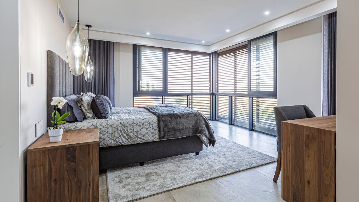 Natural light enters this bedroom through glass windows with screens.