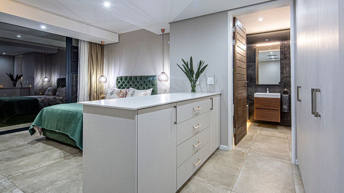 Cabinetry in white and a bathroom doorway are on the side.
