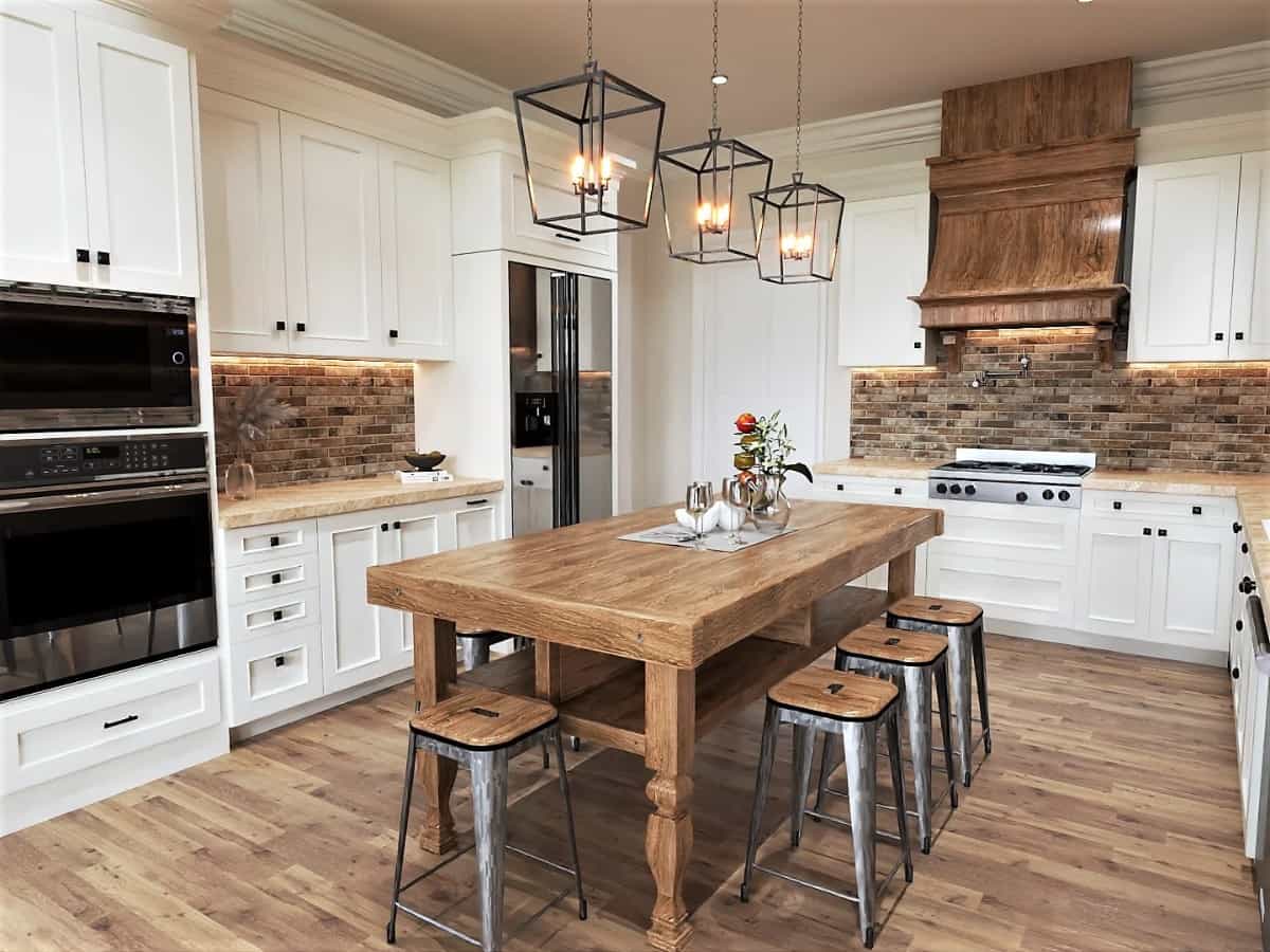 White cabinets and granite counters surround the kitchen island.