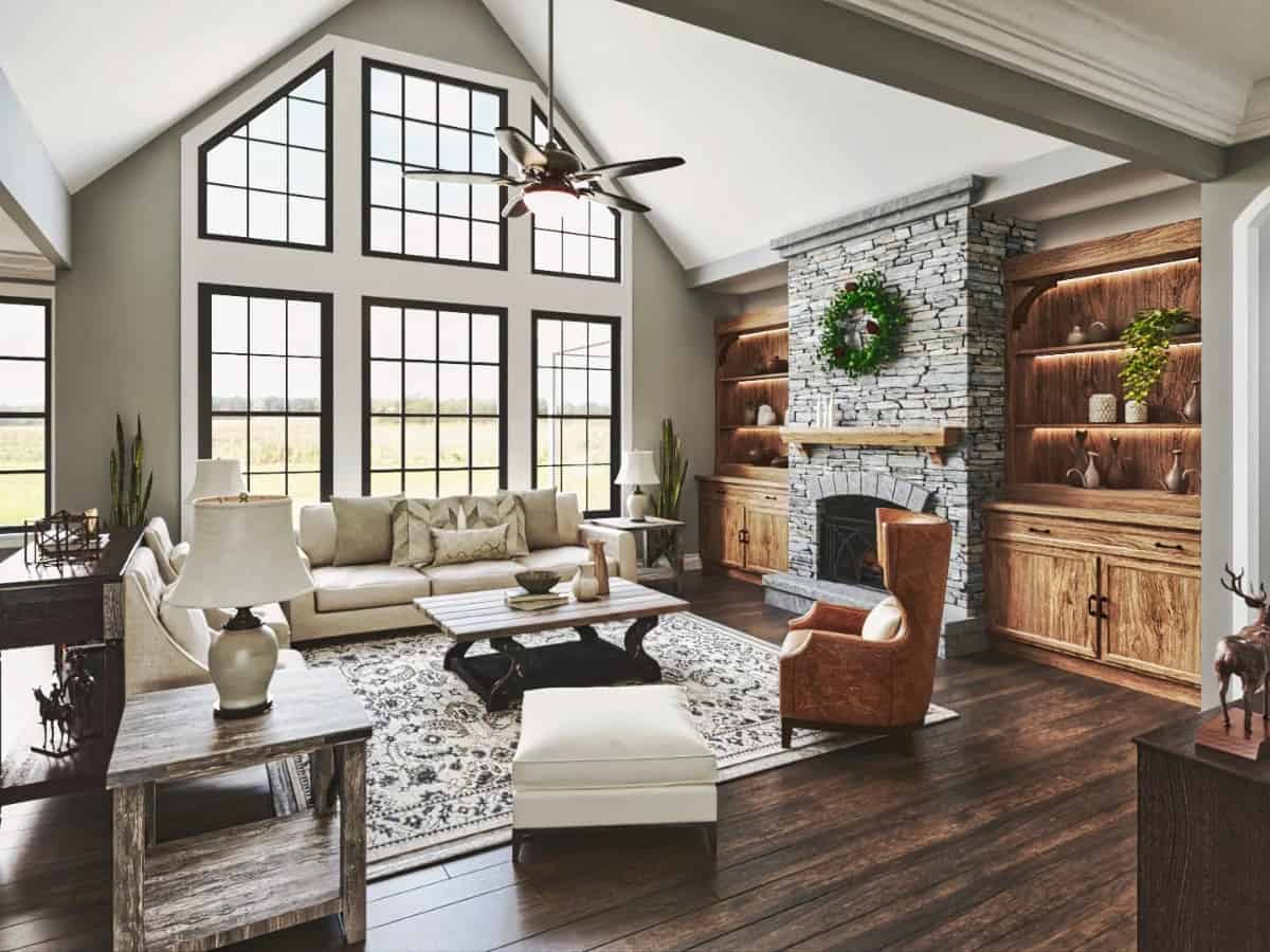 The grand room has a cathedral ceiling, a stone fireplace, and massive windows that take in ample natural light and expansive views.