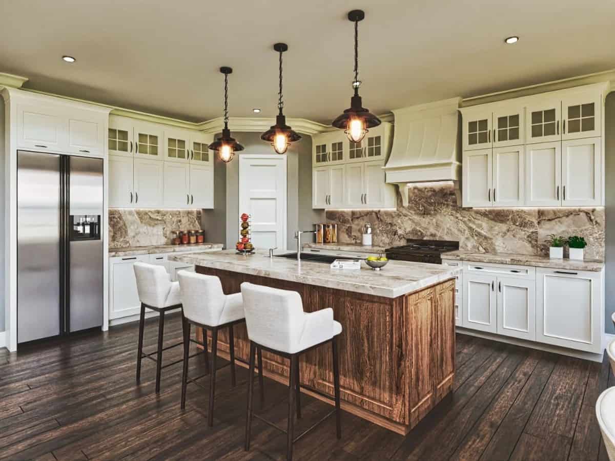 The kitchen offers lots of storage, premium appliances, and a breakfast island illuminated by warm pendants.