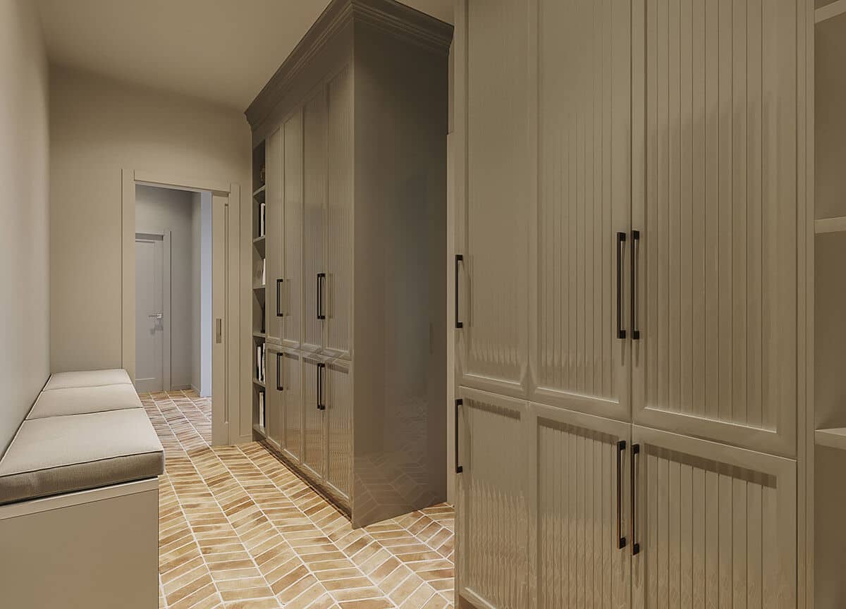 The mudroom is filled with a built-in bench and floor-to-ceiling cabinets.