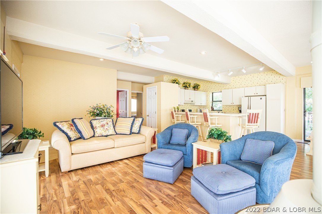 The guest living room features wooden flooring and cozy sofa.