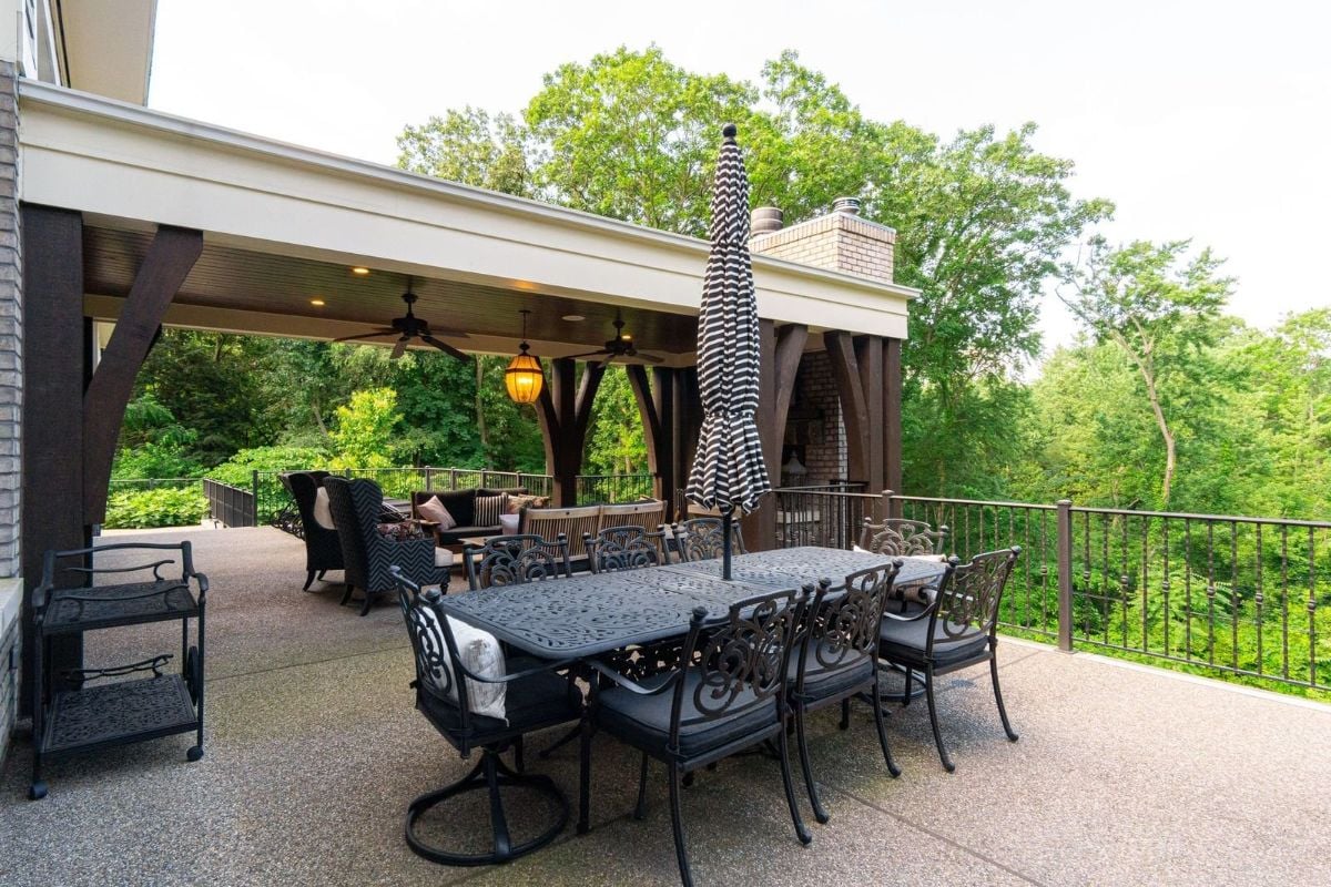 The open dining area features a metal table and a view of the surroundings.