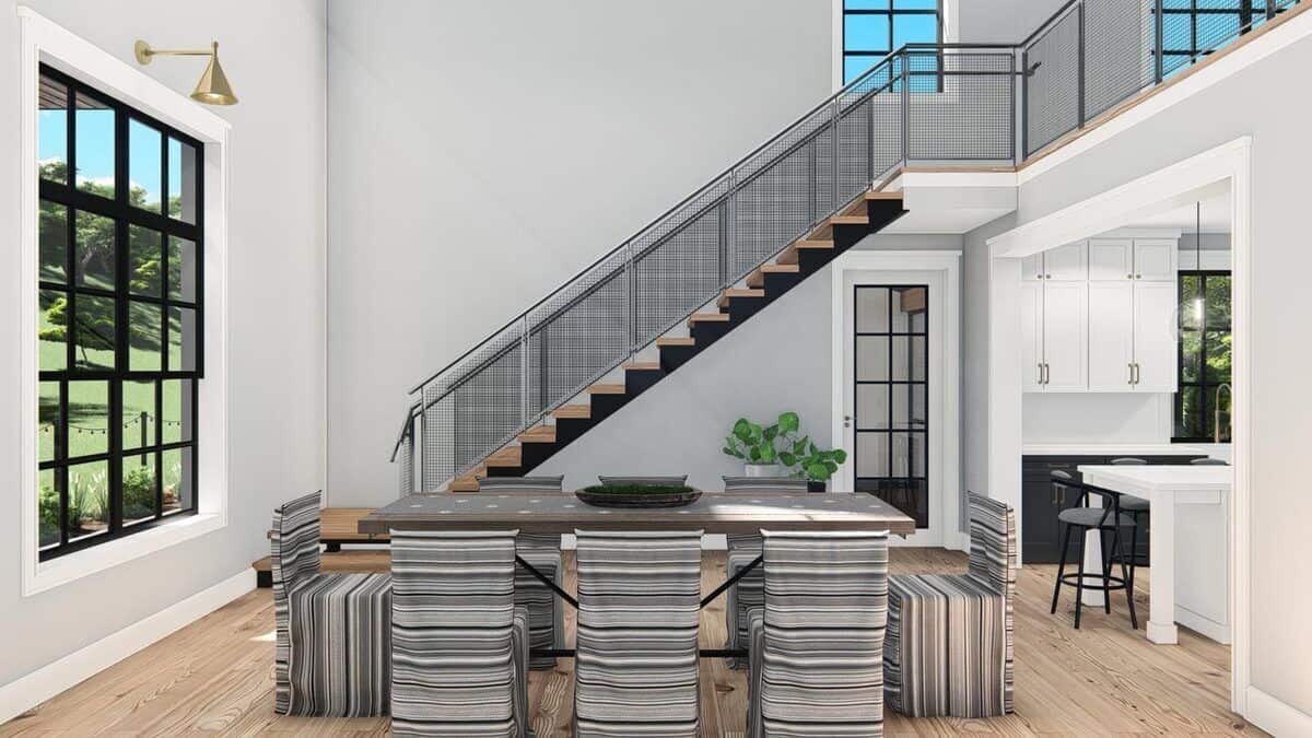 The dining area features a wooden dining table paired with striped chairs.