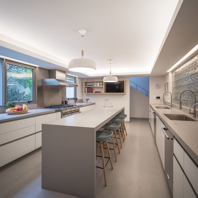 A kitchen design that features a spacious island as its centerpiece, complete with bar stools for comfortable seating.