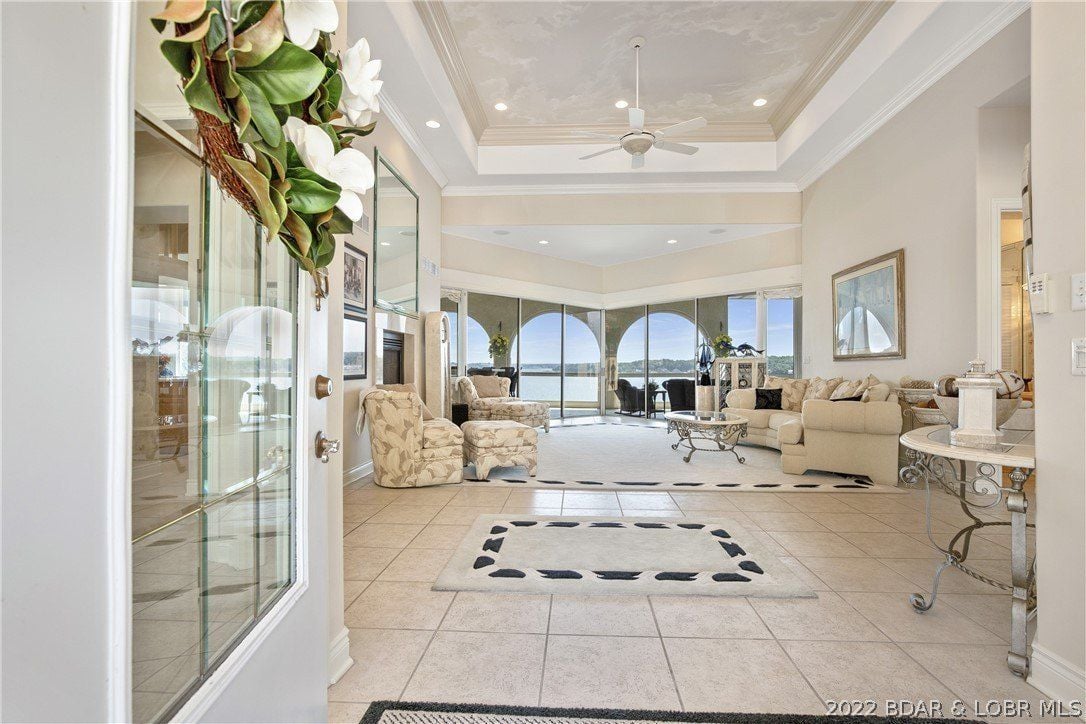 The entrance features a high ceiling and an area rug giving off a welcoming feel to the house.