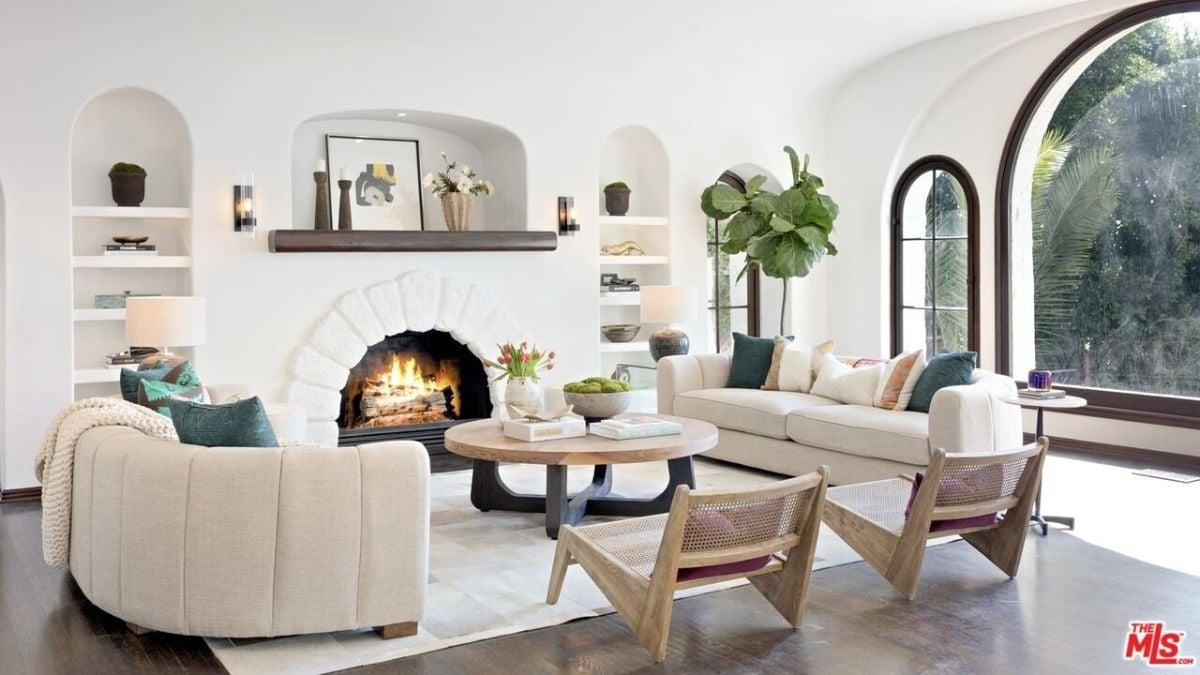 The living room features a fireplace and a sectional sofa that blends well with the area rug.