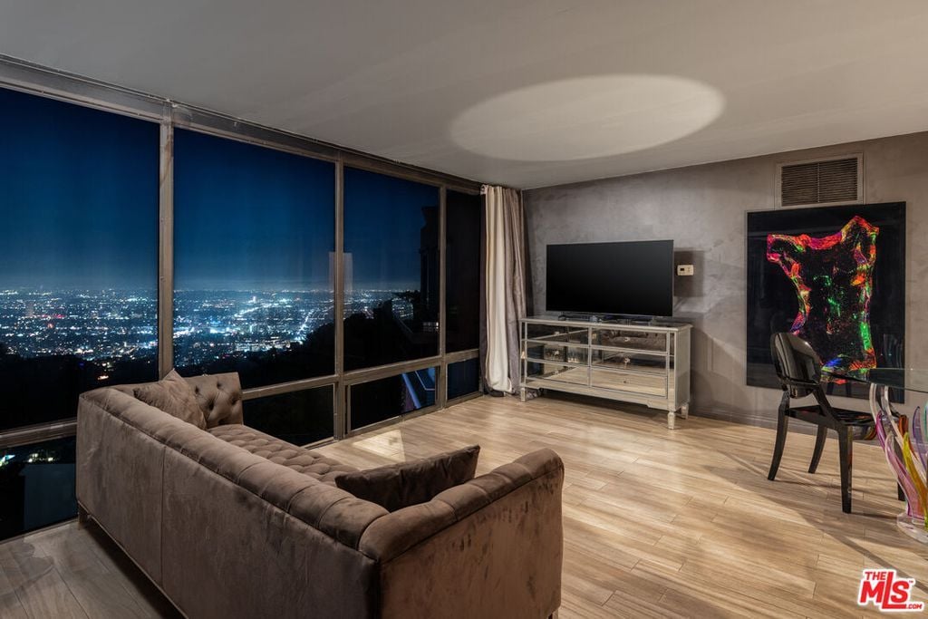 The comfortable sofa in the living room was positioned to take full advantage of the stunning view through the floor-to-ceiling glass windows.