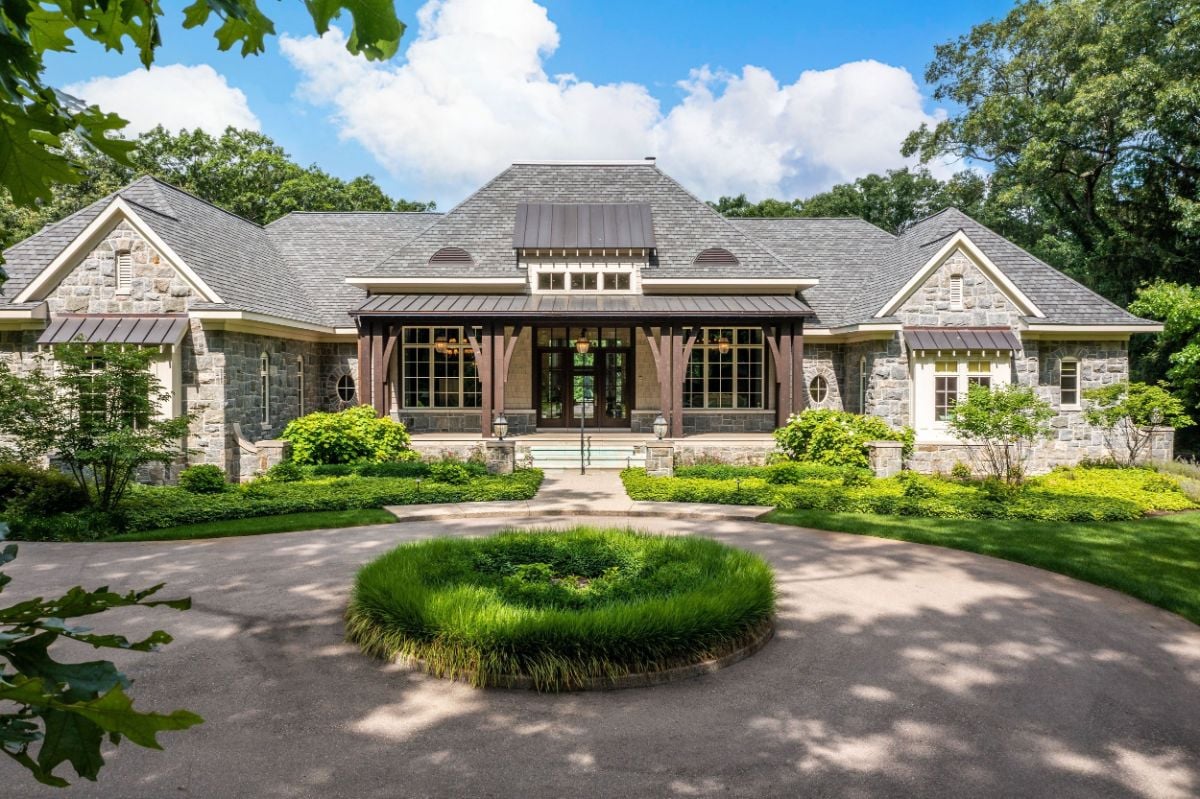 The entrance to the house features a concrete walkway and a covered porch.