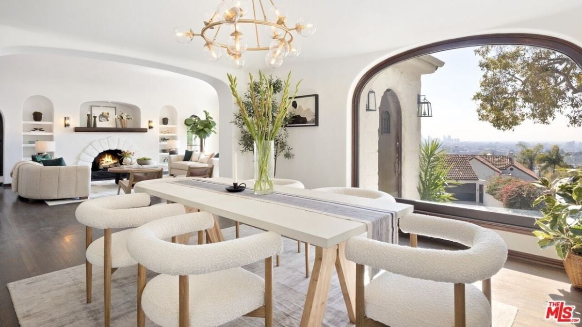 The dining room boasts unobstructed city views through the large arched windows, which bathes the original interior details in gorgeous natural light.