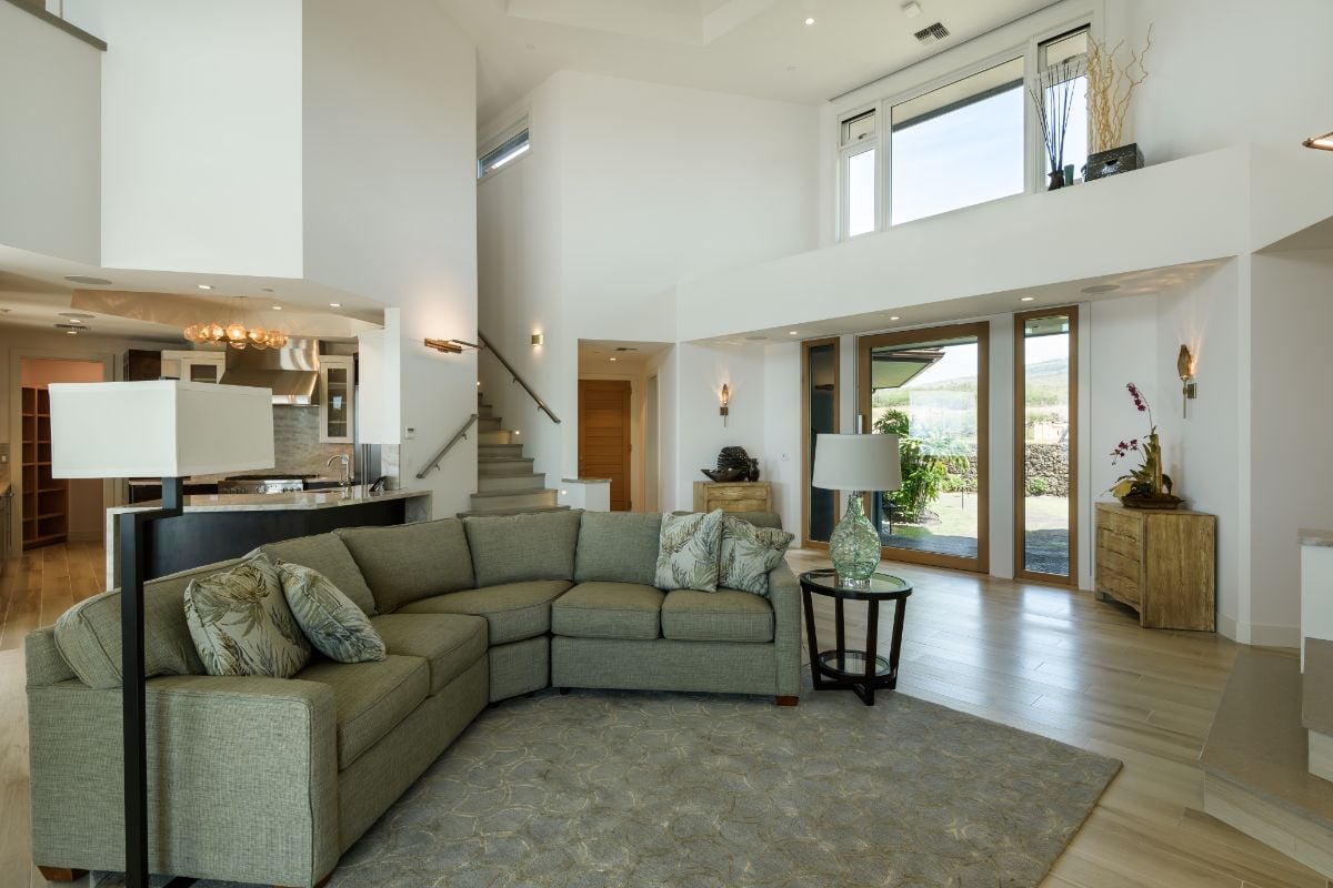 The living room features a sectional sofa and an area rug.