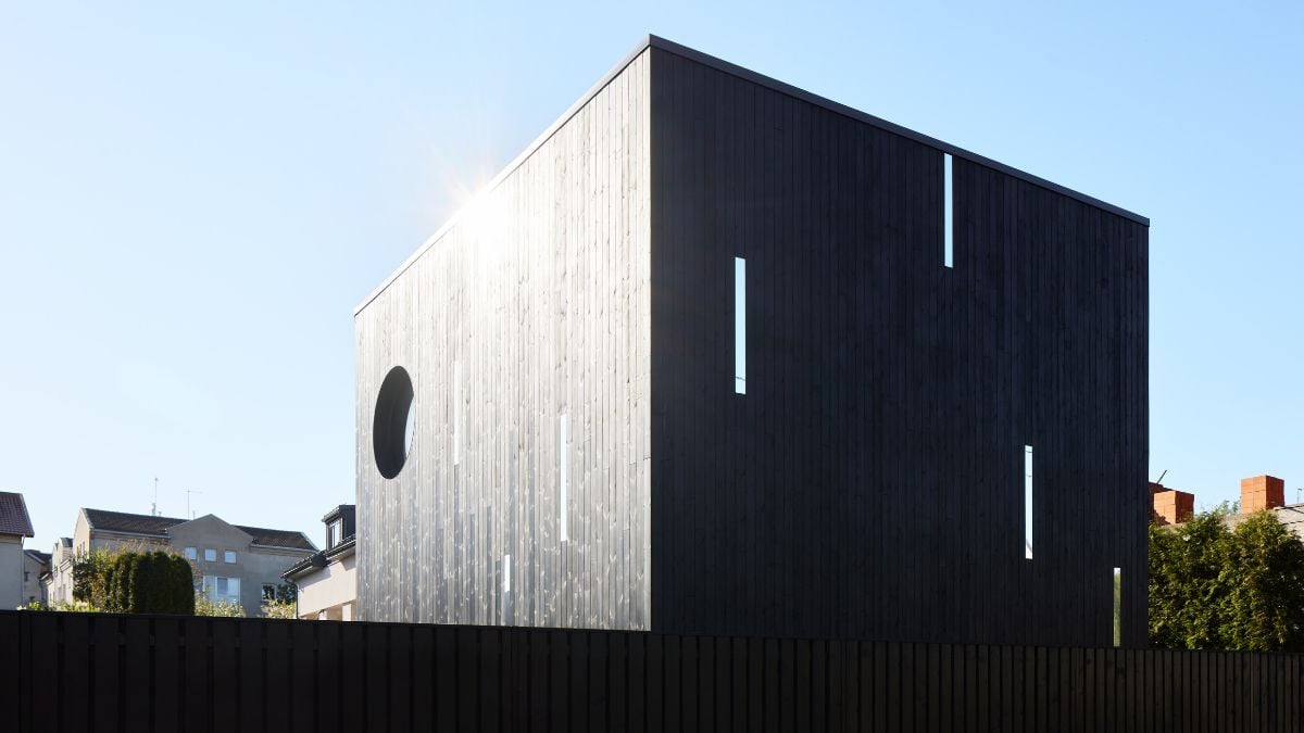 The house's distinctive dark color scheme sets it apart from others.
