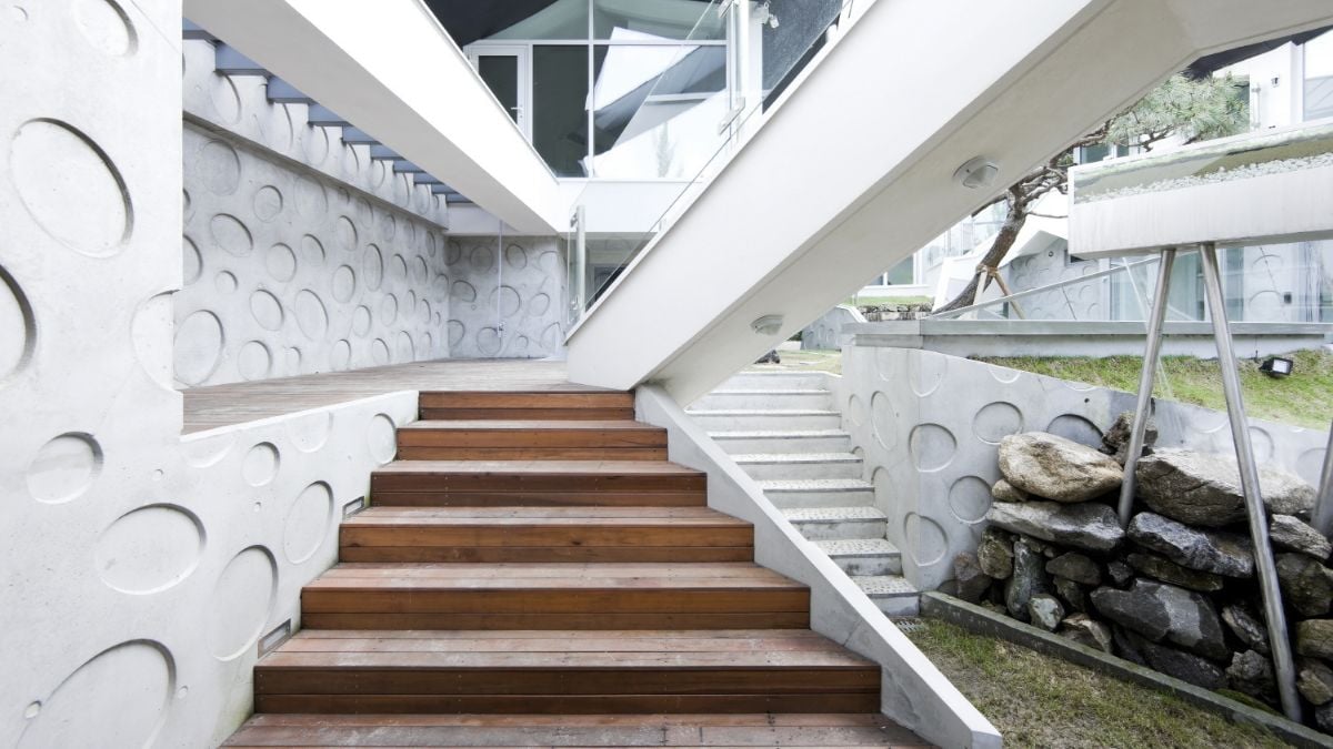 The structures at the entrance are made of matched cement, wood, and stone.