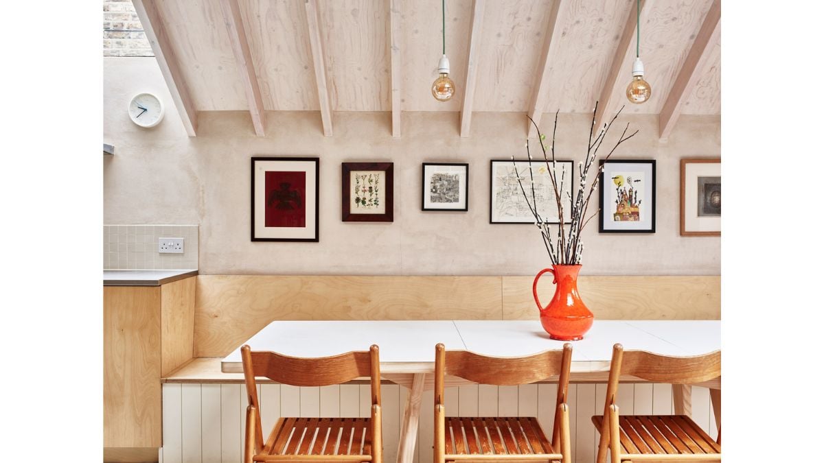 The column is positioned naturally between the dining area and kitchen, which are enclosed by a sloped portion of the roof.