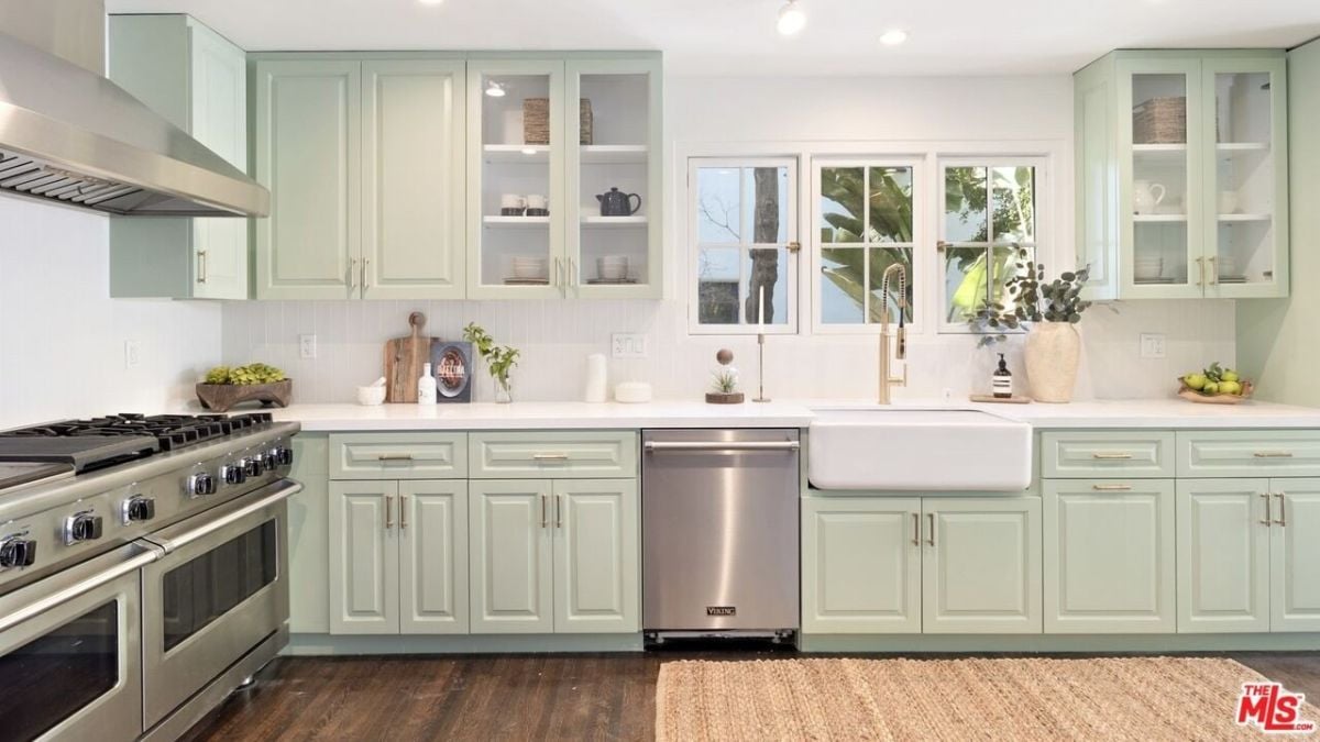 The original hardwood floors lead you to the fun sage green kitchen with top-of-the-line appliances.