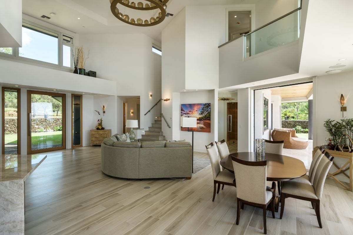 The dining features a wooden table with glass windows showcasing the view outside.