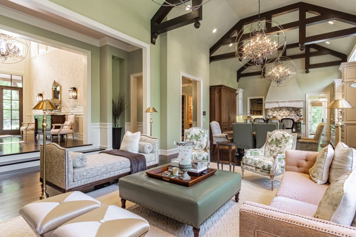The living room features a sofa, a leather center table, and a chaise giving off a luxurious feel.